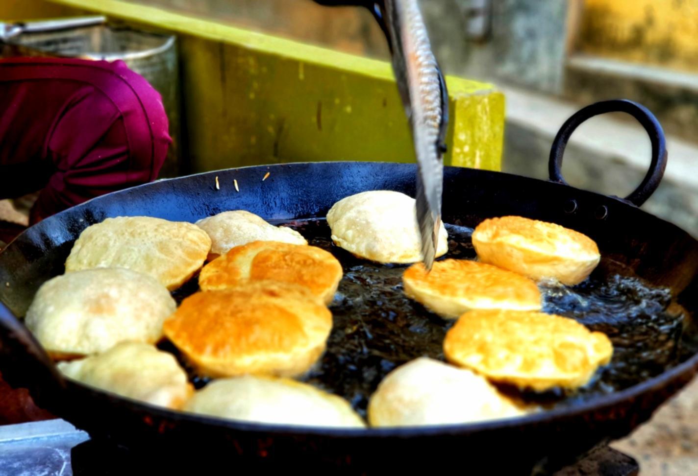 Participants learning precision cooking techniques in modern kitchen facility